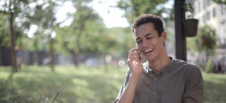 Smiling man talking on the phone with local movers MD.