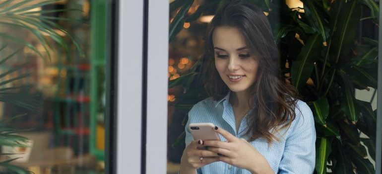 A woman holding a phone.